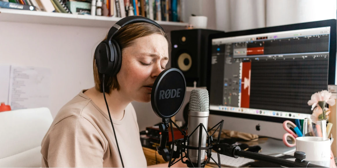 Person recording audio in a comfortable coworking space