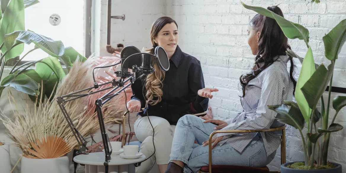 Two people recording a podcast episode together