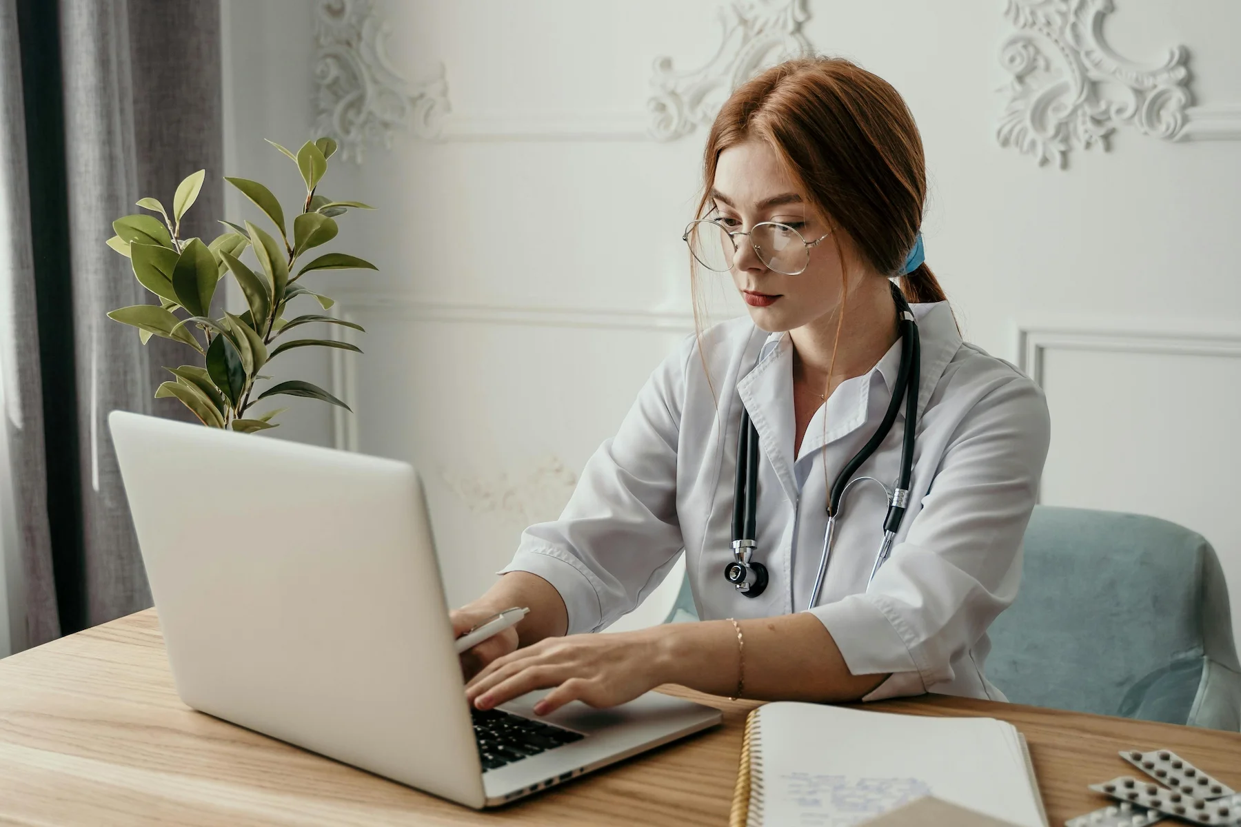 Doctor working on computer in medical coworking facility