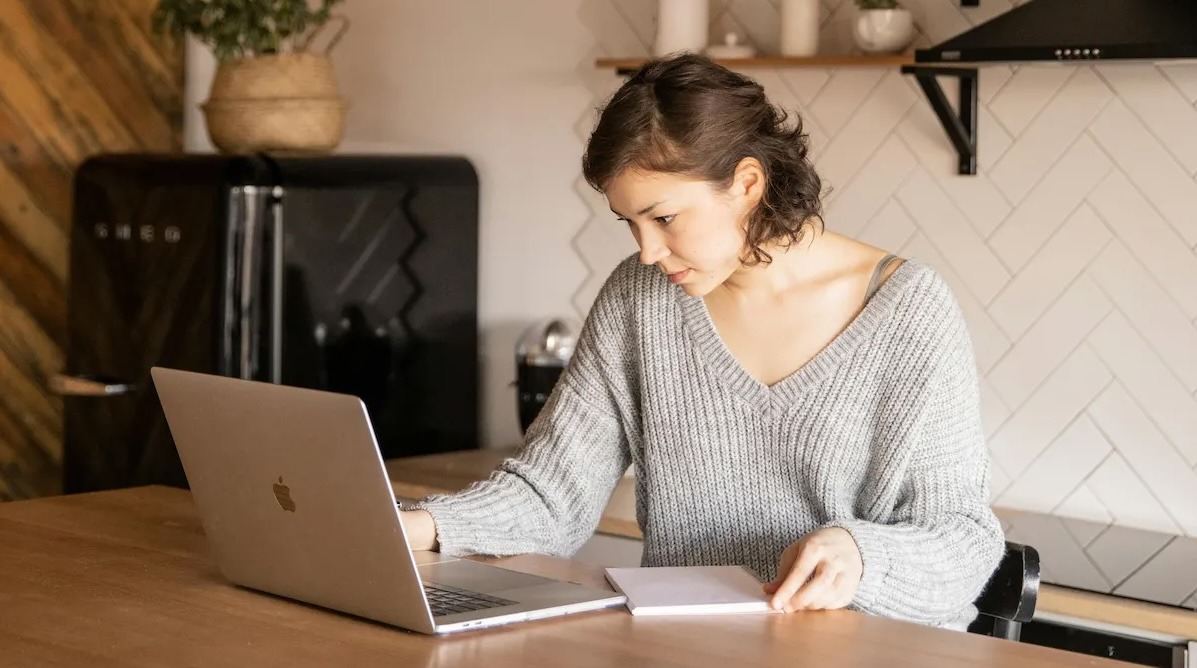 Person working at computer in a kitchen space